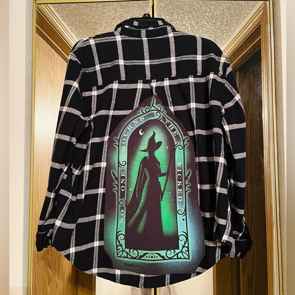 Women’s black & white flannel with Wicked graphic t-shirt sewn on the back.